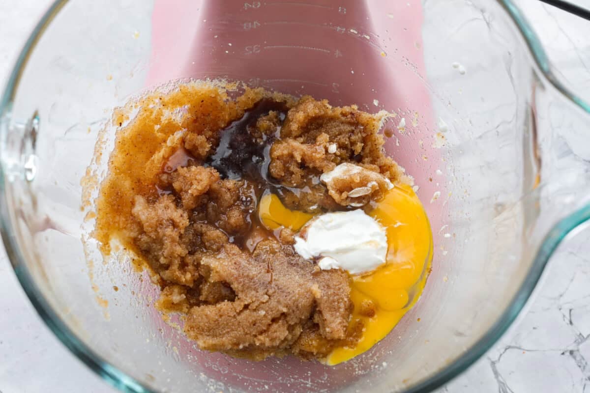 Eggs, vanilla, and sour cream added to the sugar and butter mixture.