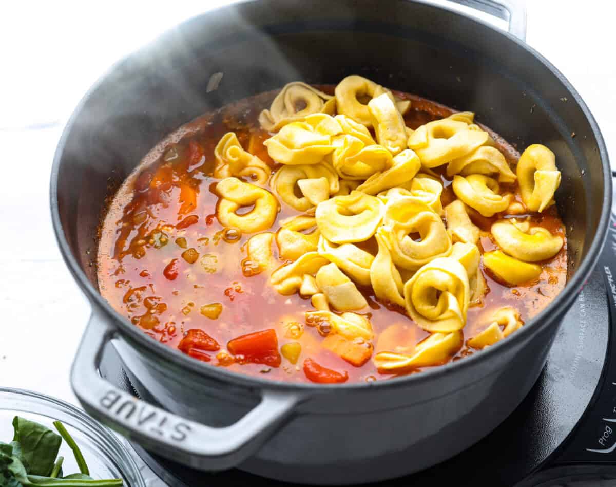 My love of cozy soups kicks in the second summer fades. This creamy tortellini soup gives me all the fall vibes. Fresh veggies, cheesy pasta, and a creamy broth, it's comfort in a bowl. You’ve got to try it today! Tortellini added to the broth and veggie mixture.
