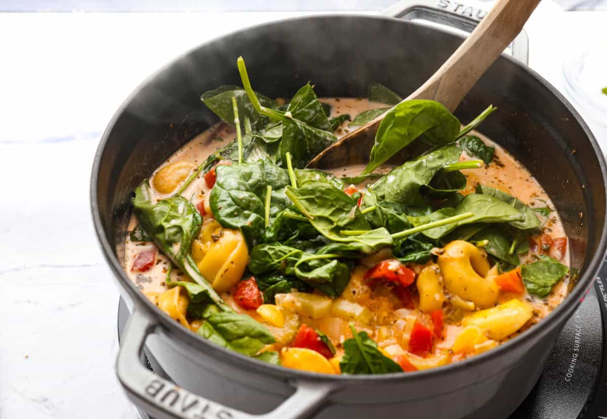 My love of cozy soups kicks in the second summer fades. This creamy tortellini soup gives me all the fall vibes. Fresh veggies, cheesy pasta, and a creamy broth, it's comfort in a bowl. You’ve got to try it today! Cream, cheese and spinach added to the soup.