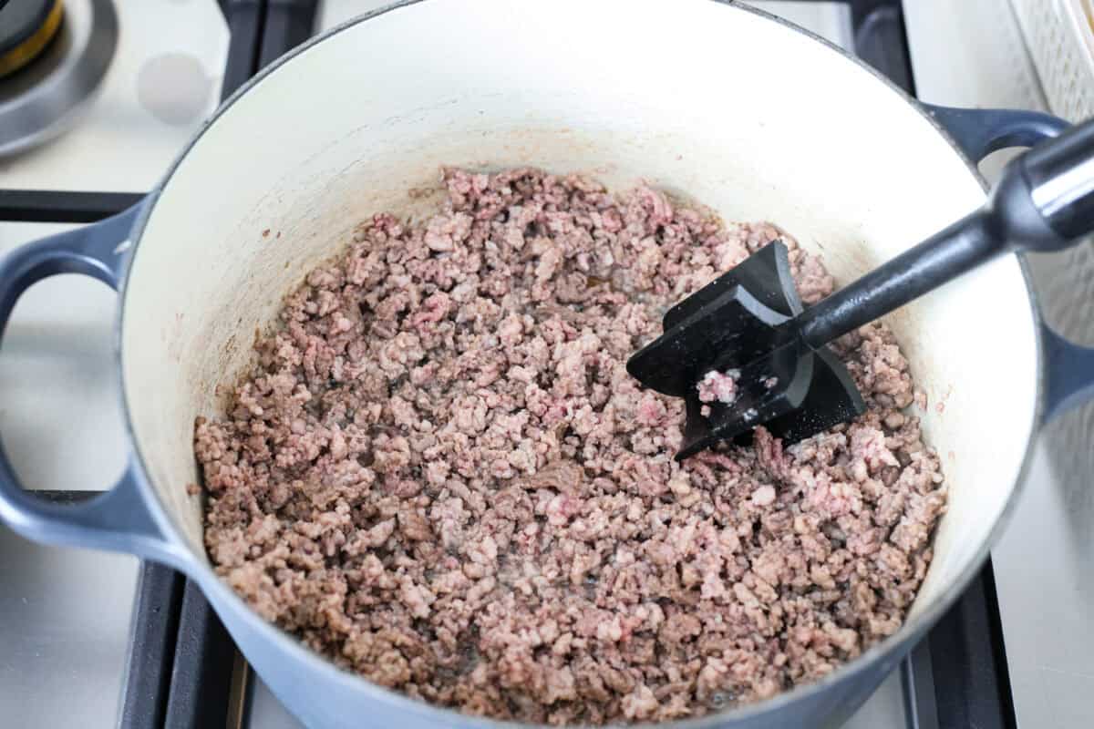 Why is it called “dirty” rice? The rice gets brown as it cooks with meat, Cajun spices, and the holy trinity of Cajun cooking: onion, bell pepper, and celery. My version combines ground pork and beef for a flavorful twist on this Louisiana classic! Ground beef and pork cooking in a pot.