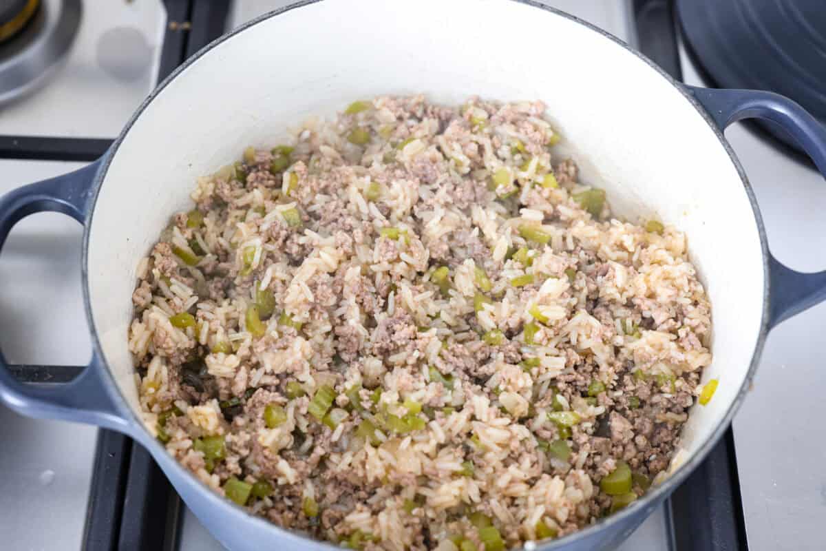 Why is it called “dirty” rice? The rice gets brown as it cooks with meat, Cajun spices, and the holy trinity of Cajun cooking: onion, bell pepper, and celery. My version combines ground pork and beef for a flavorful twist on this Louisiana classic! Dirty rice all cooked and fluffed ready to be served.