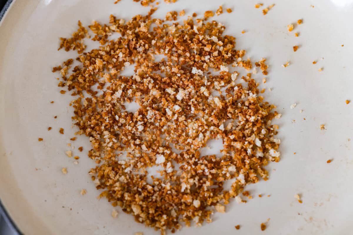 Meet my Fried Pickle Dip...a viral take on my popular pickle dip! The toasted bread crumbs elevate the flavors with the crunchy "fried" texture. Panko bread crumbs browning in a pan with. butter.