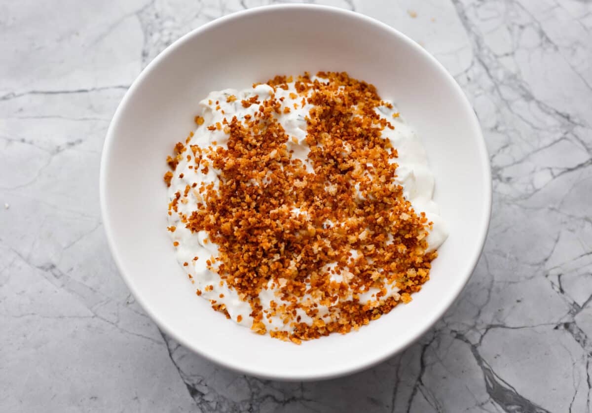 Meet my Fried Pickle Dip...a viral take on my popular pickle dip! The toasted bread crumbs elevate the flavors with the crunchy "fried" texture. Crispy breadcrumbs added to the top of the dip.