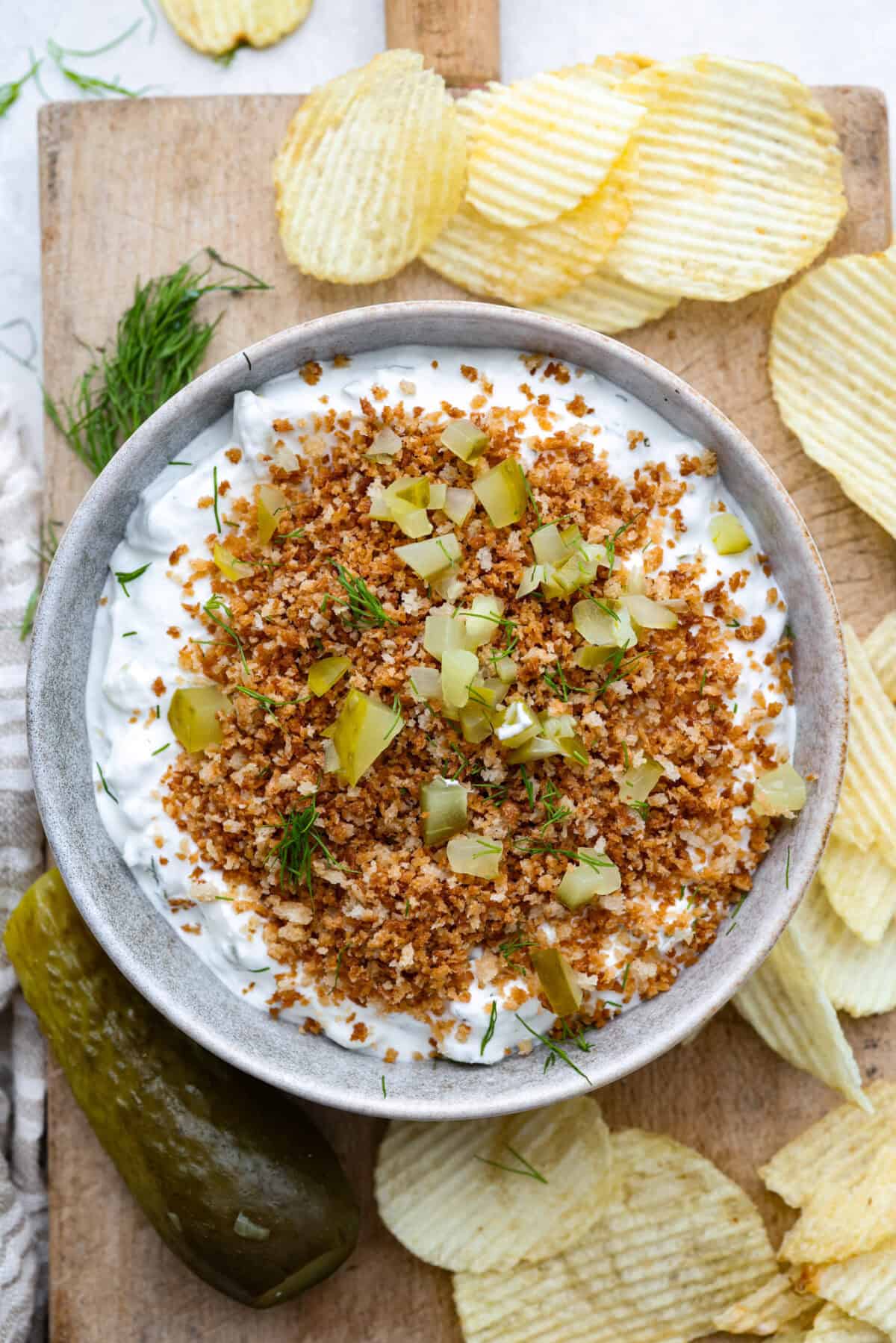 Meet my Fried Pickle Dip...a viral take on my popular pickle dip! The toasted bread crumbs elevate the flavors with the crunchy "fried" texture. Overhead shot of a bowl of fried pickle dip.