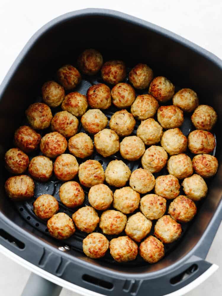 Okay, hear me out, frozen meatballs in the air fryer are a total game-changer. They come out crispy on the outside, juicy on the inside, and taste like you made them from scratch (but without the effort). I use them ALL the time! Air fryer frozen meatballs in the air fryer basket.