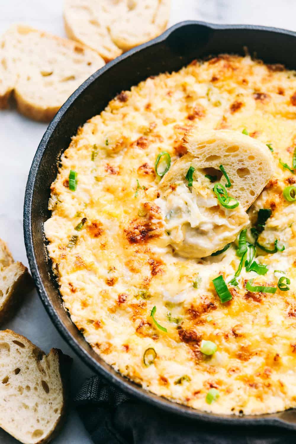 Small Crockpot Method: Keep your dip warm for parties or get-togethers. Use a 2-quart slow cooker on LOW for 1–2 hours, until hot and melted. Your dip will stay warm and melty for up to 2 hours. Hot Crab Dip in a metal pan with sliced bread on the side.