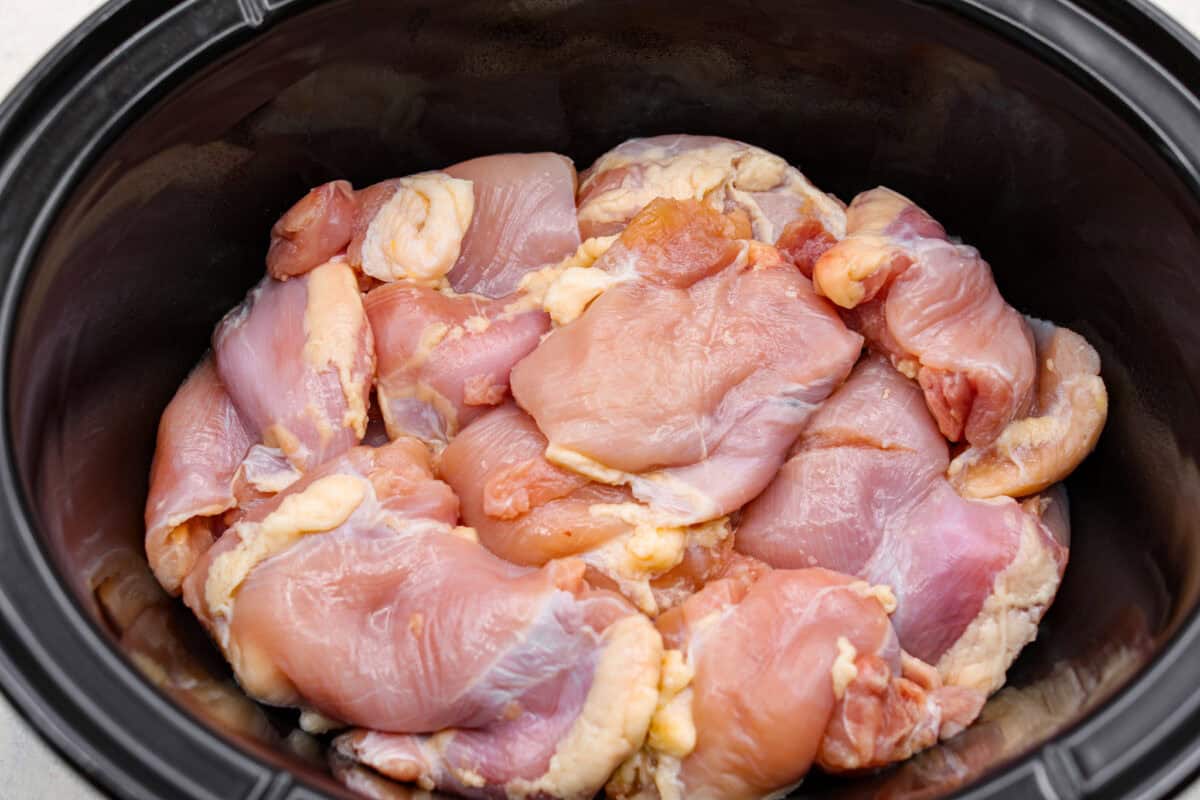 Set it and forget it! This slow cooker Korean BBQ chicken is sweet, savory, and just the right amount of spice. Perfect for tossing over rice, piling onto buns, topping a salad, or even making tacos. Weeknight dinner just got easier! Chicken thighs added to the bottom of the slow cooker.