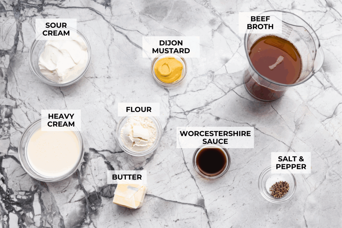 Turn those flavorful pan drippings into the creamiest gravy with a hint of tang. This sour cream gravy is rich, smooth, and so versatile. It's perfect over mashed potatoes, pork chops, but especially on my favorite Swedish Meatballs. Overhead shot of labeled sour cream gravy ingredients.