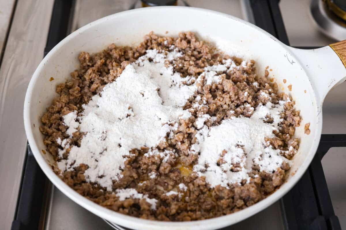 Forget the usual biscuits and gravy, this version takes everything you love and turns it into one irresistible, bubbly casserole. Creamy sausage gravy, buttery biscuits, and zero stress. Flour mixture spread over the cooked sausage.