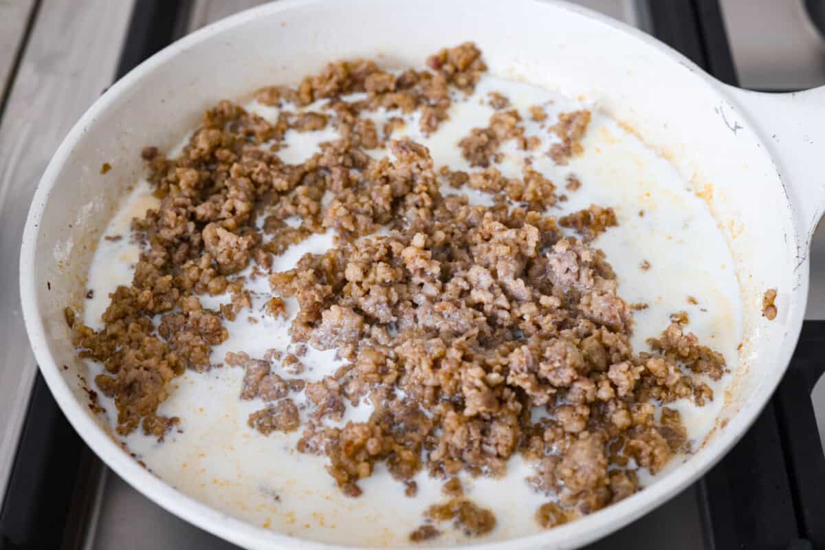 Forget the usual biscuits and gravy, this version takes everything you love and turns it into one irresistible, bubbly casserole. Creamy sausage gravy, buttery biscuits, and zero stress. Milk and cream added to the sausage and flour mixture.
