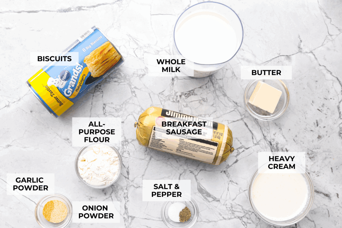 Forget the usual biscuits and gravy, this version takes everything you love and turns it into one irresistible, bubbly casserole. Creamy sausage gravy, buttery biscuits, and zero stress. Overhead shot of labeled ingredients.