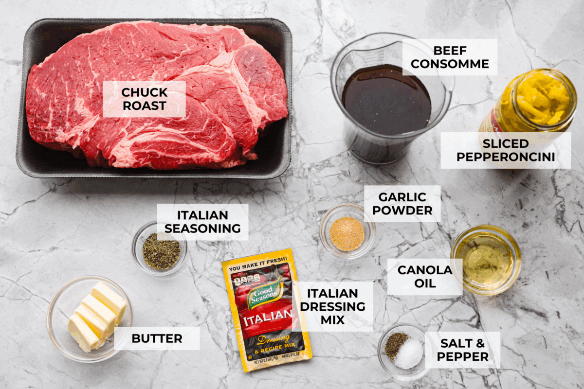 My Slow Cooker Italian Beef is tender, juicy, and loaded with zesty Italian flavor. The secret's in the way you sear the beef! This creates melt-in-your-mouth meat perfect for sandwiches or hearty dinners. Overhead shot of labeled slow cooker Italian beef ingredients.