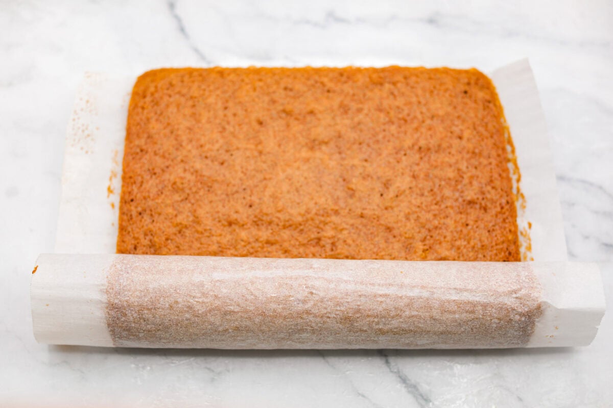 Rolling the cake up with the parchment paper while still warm and letting it cool rolled up.