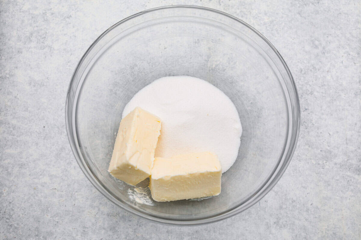 Meet the upgraded Twix thumbprint cookies! I re‑tested and updated the recipe so you'll get defined wells, clean edges, and a tender center every time! They are perfect for gift giving and cookie parties! Sugar and butter in a mixing bowl.