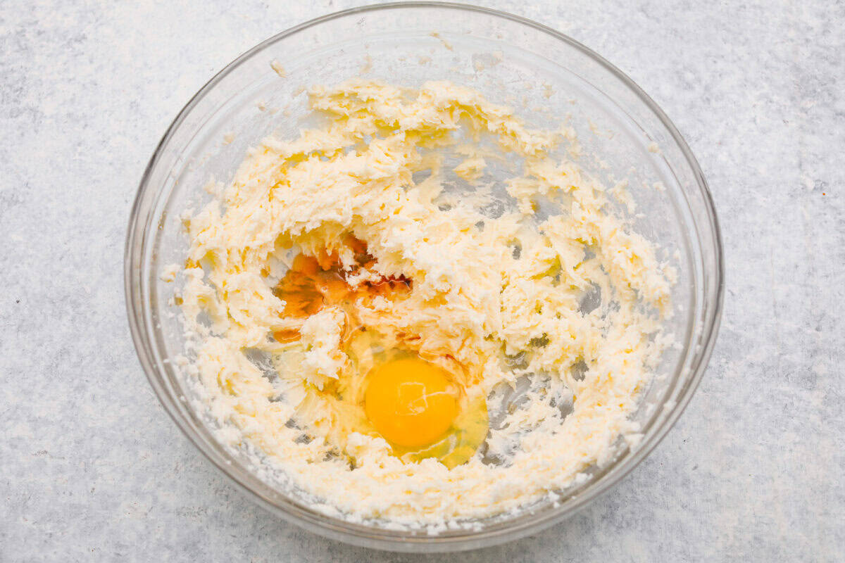 Meet the upgraded Twix thumbprint cookies! I re‑tested and updated the recipe so you'll get defined wells, clean edges, and a tender center every time! They are perfect for gift giving and cookie parties! Egg and vanilla added to the beaten butter and sugar.