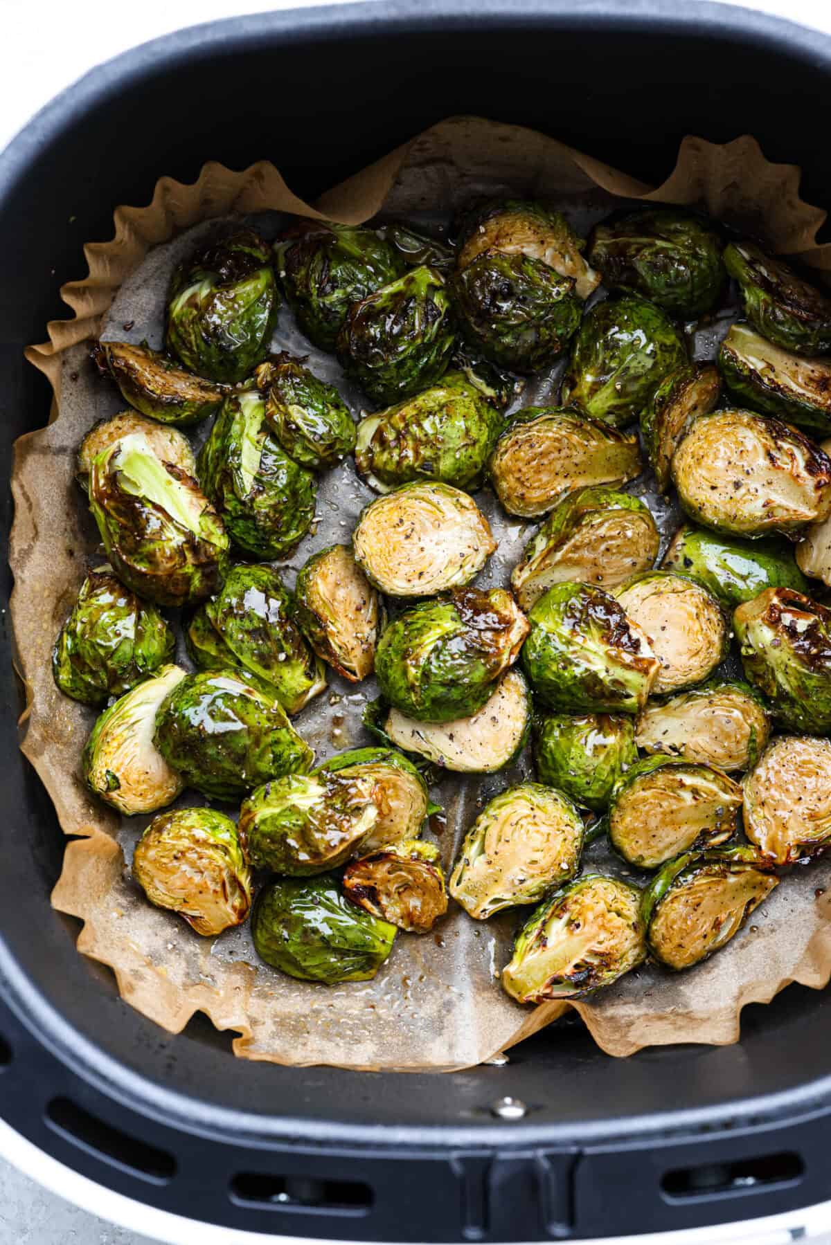 Cooked air fryer Brussels sprouts still in the air fryer basket. 