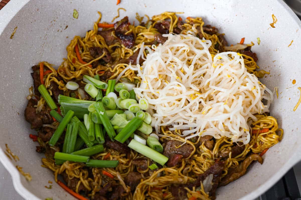 Cooked noodles stirred in and green onions and bean sprouts added to the beef mixture. 