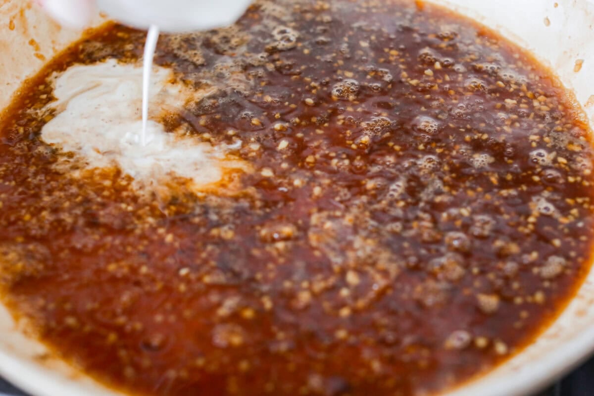 Cornstarch slurry being added to the marinade. 