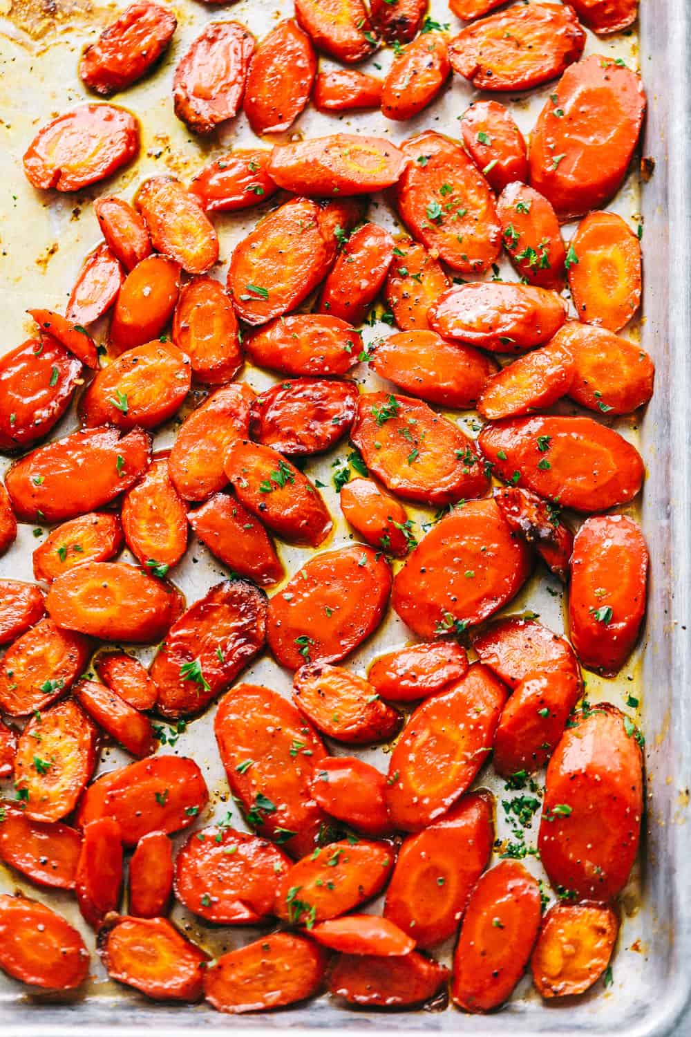 Brown Sugar glazed carrots are that sneaky-simple side that always gets rave reviews. The brown sugar caramelizes into the best buttery sweetness, and somehow everyone ends up going back for seconds. Brown sugar glazed carrots cooked and on a tray.