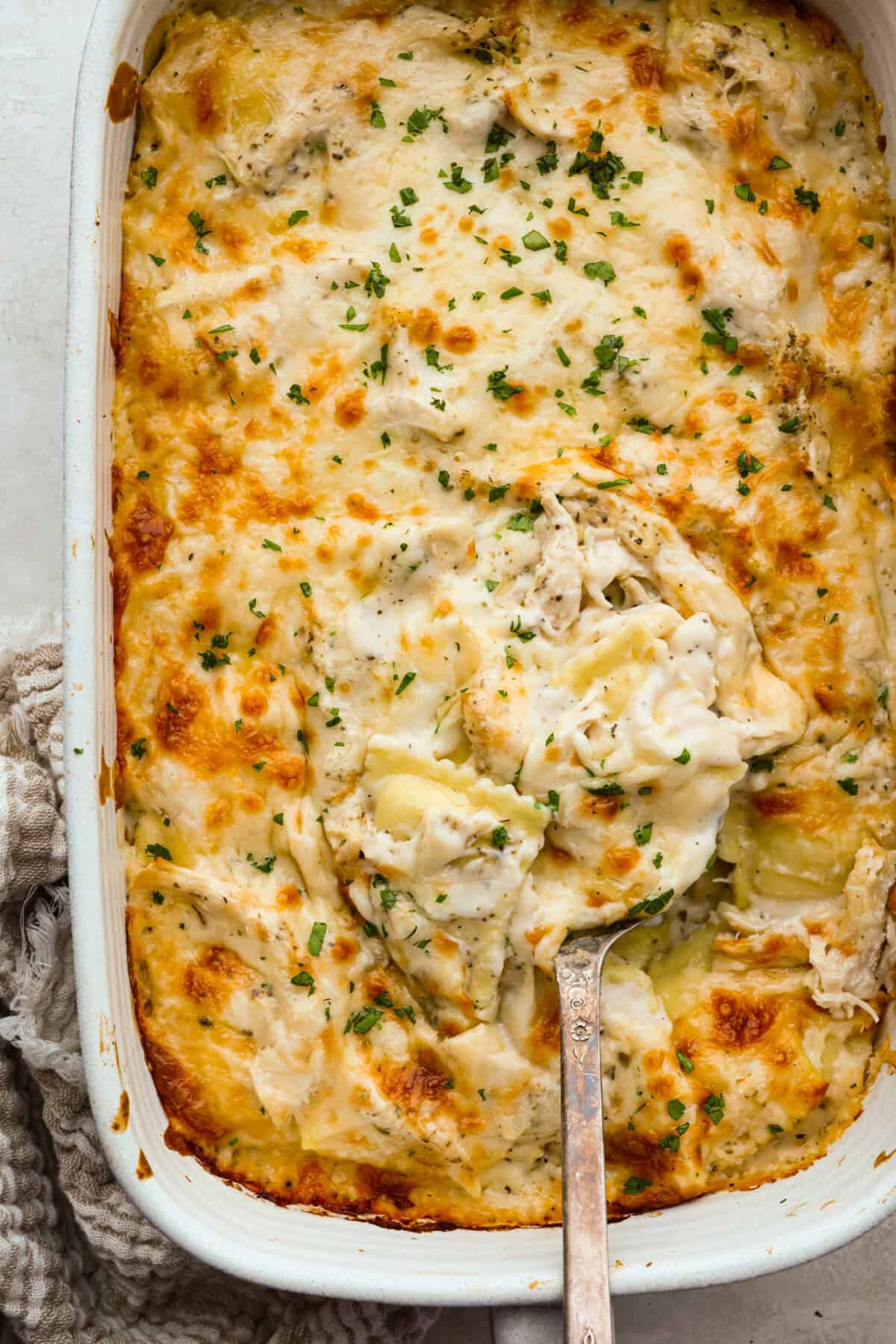 Top down shot of the baked Alfredo ravioli casserole. 
