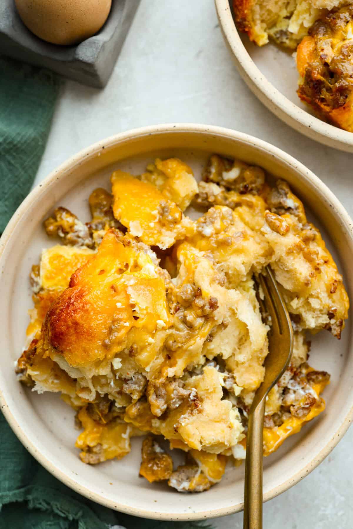 Wake up to a breakfast that feels like a warm hug! This Christmas morning casserole turns sausage, eggs, cheese, and fluffy biscuits into the easiest, hearty breakfast you can't get enough of! Serving of Christmas breakfast casserole.