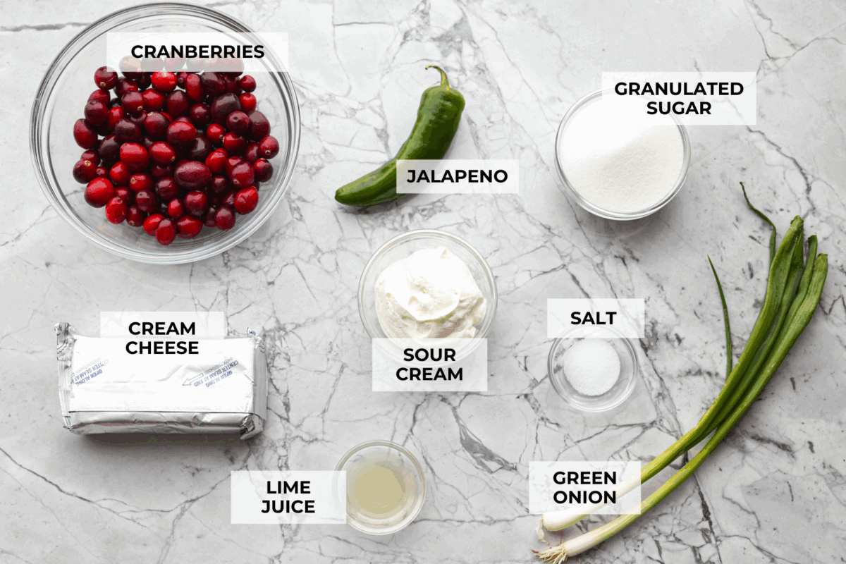 This cranberry jalapeño dip is my fresh take on the cult favorite Costco version. It's bright, tangy, a little spicy, and wildly easy to make at home. It’s the same addictive flavor, but you get to make it how you like! Overhead shot of labeled ingredients.