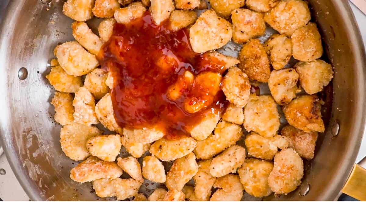 Crispy, saucy, and packed with flavor, this sweet chili chicken is a weeknight winner! Tender chicken bites get a crunchy coating, then get tossed in a sticky, sweet, and slightly spicy sauce that’s impossible to resist. Sweet chili sauce added to the pan fried chicken.