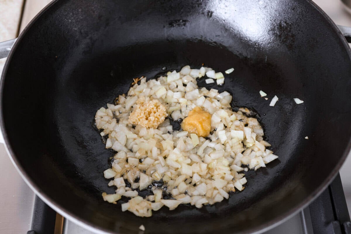 If you haven’t tried egg roll in a bowl yet, you’re in for a treat. Everything you love inside of an egg roll in a lighter, healthier, no-wrapper version! It's ready in 15 minutes, making it a perfect weeknight meal! Onions, garlic and fresh ginger added to a skillet.