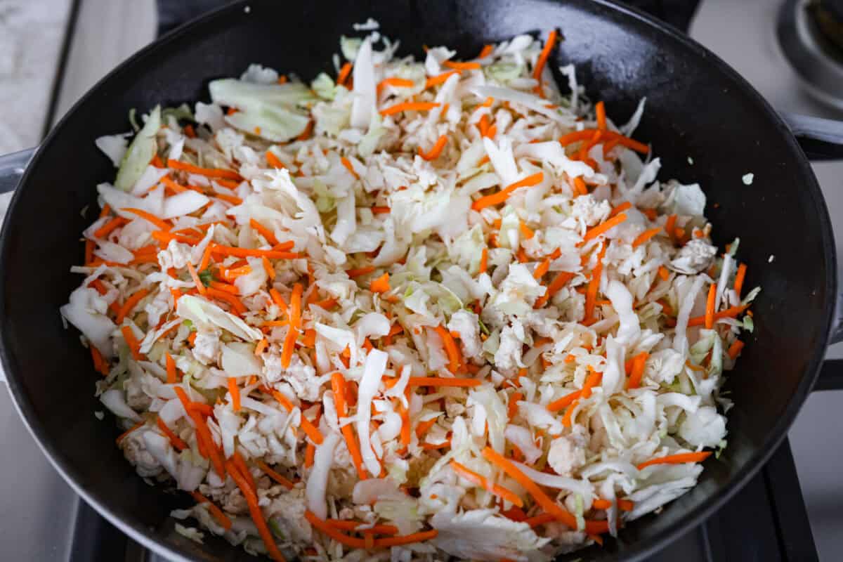 If you haven’t tried egg roll in a bowl yet, you’re in for a treat. Everything you love inside of an egg roll in a lighter, healthier, no-wrapper version! It's ready in 15 minutes, making it a perfect weeknight meal! Coleslaw mix added to the skillet to cook down.