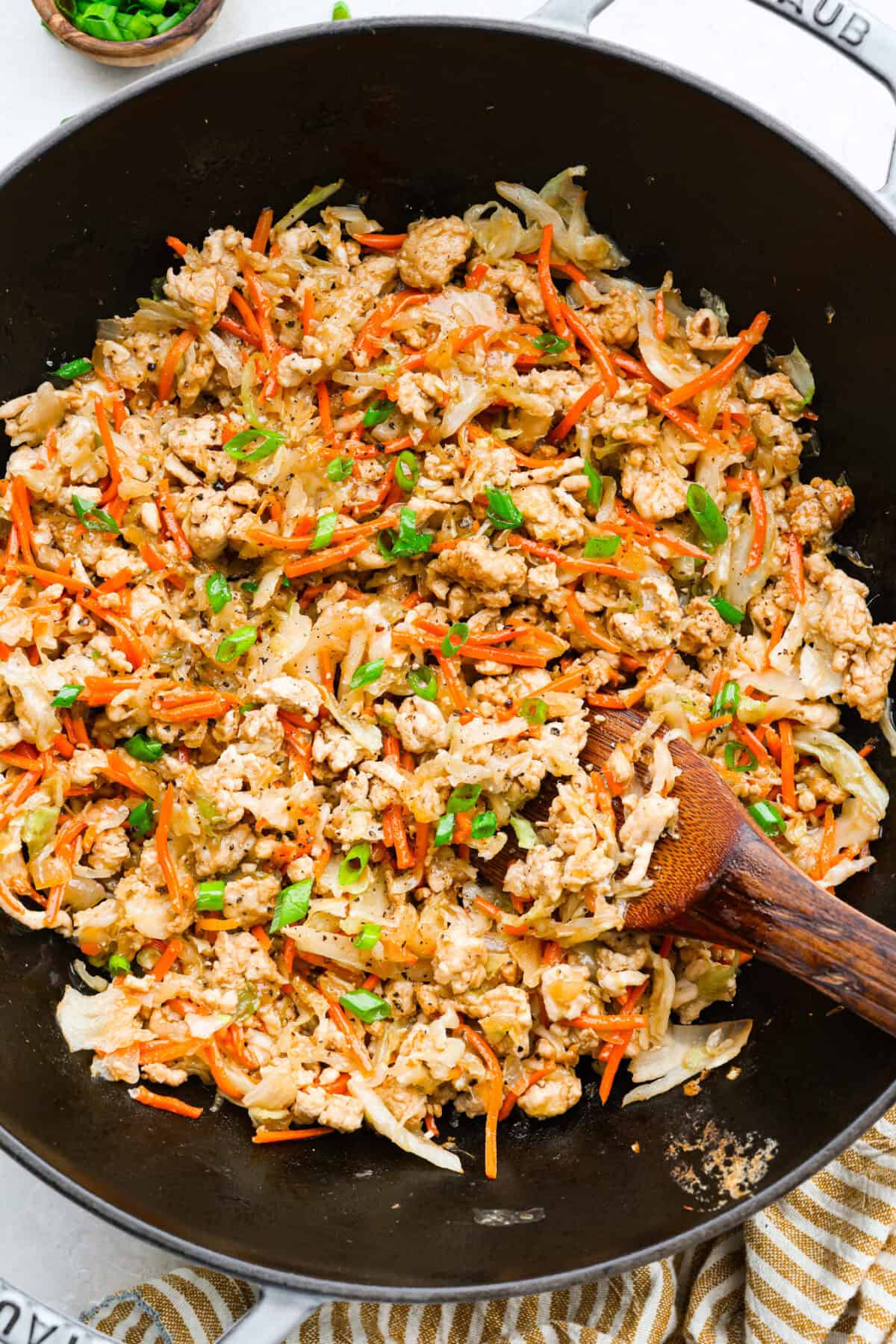 If you haven’t tried egg roll in a bowl yet, you’re in for a treat. Everything you love inside of an egg roll in a lighter, healthier, no-wrapper version! It's ready in 15 minutes, making it a perfect weeknight meal! Egg roll in a bowl all cooked and ready to serve.