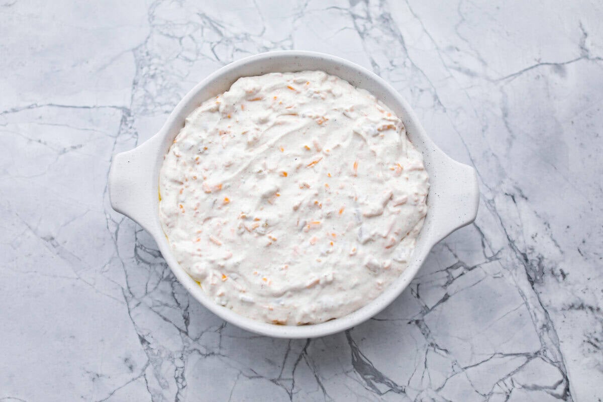 This green chile dip is warm, creamy, and so easy! The best part is, you get to control the heat! I'm telling you, the flavor hits bigger than the ingredient list! Make this for your next get-together, or let's be real, lunch! Dip ingredients mixed together and spread out in a baking dish.