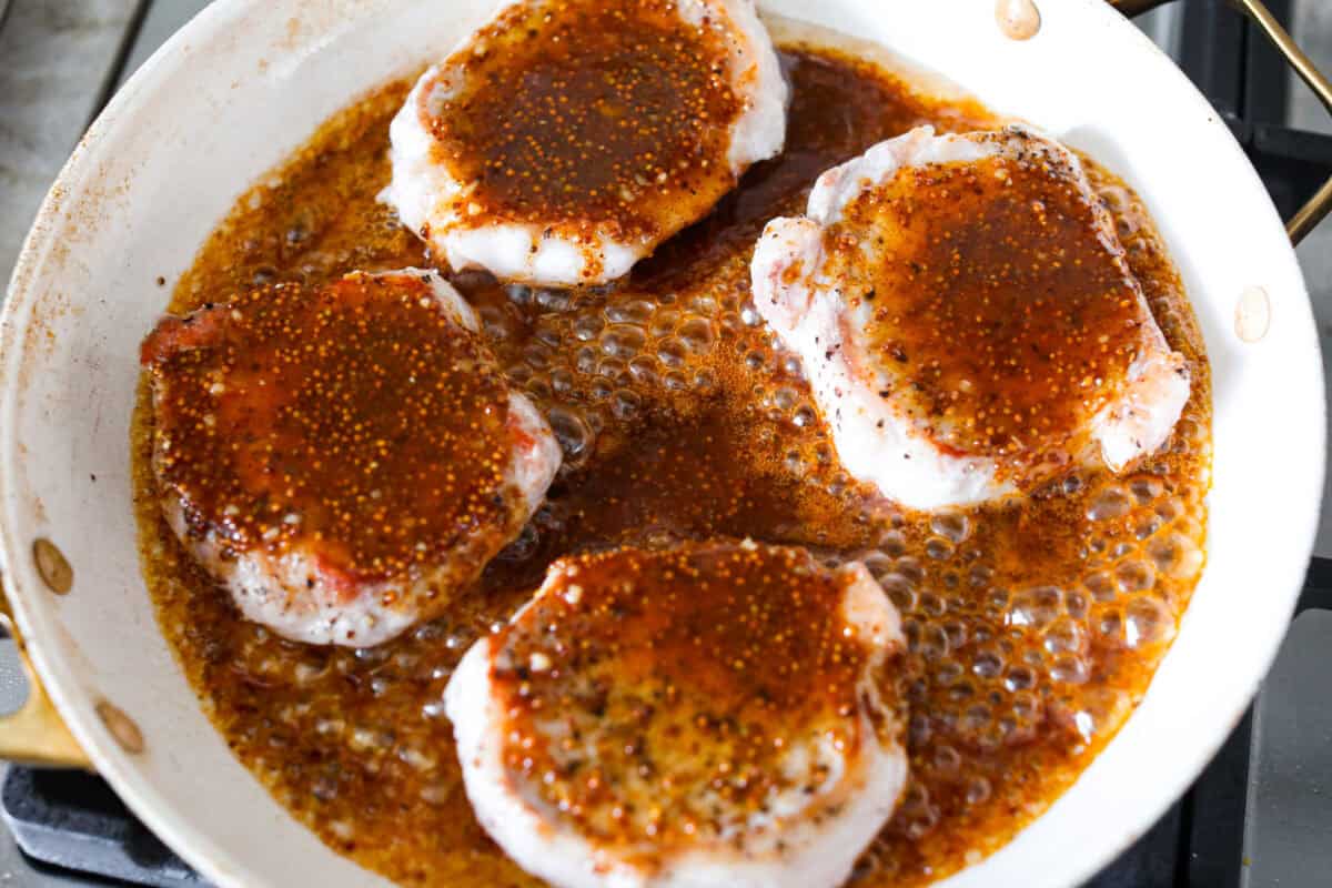 Sauce added to the skillet with the chops. 