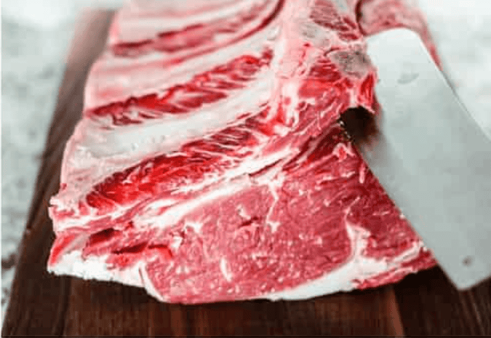 I have the perfect fool proof prime rib recipe for you. I have done all of the testing for you so that you can achieve the perfect prime rib every single time. Melt in your mouth, cooked perfectly to medium rare with a perfect garlic butter crust, this recipe is incredible. I will help you feel confident every step of the way! Prime rib roast being cut and prepped for wrapping.