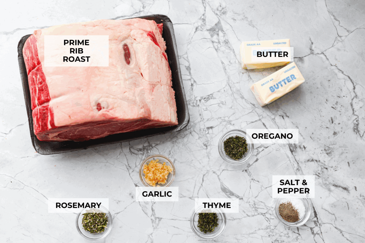 I have the perfect fool proof prime rib recipe for you. I have done all of the testing for you so that you can achieve the perfect prime rib every single time. Melt in your mouth, cooked perfectly to medium rare with a perfect garlic butter crust, this recipe is incredible. I will help you feel confident every step of the way! Overhead shot of labeled ingredients.
