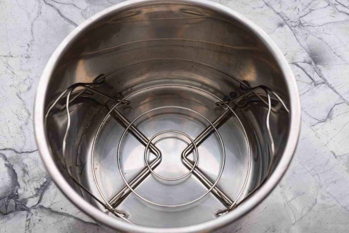 Instant pot lobster is the easiest way to bring a little luxury to your dinner table, no boiling pots or fancy techniques needed! In just minutes, the lobster cooks up tender, juicy, and perfectly steamed, ready to soak up a rich garlic herb butter. Instant pot with trivet and water added to it.