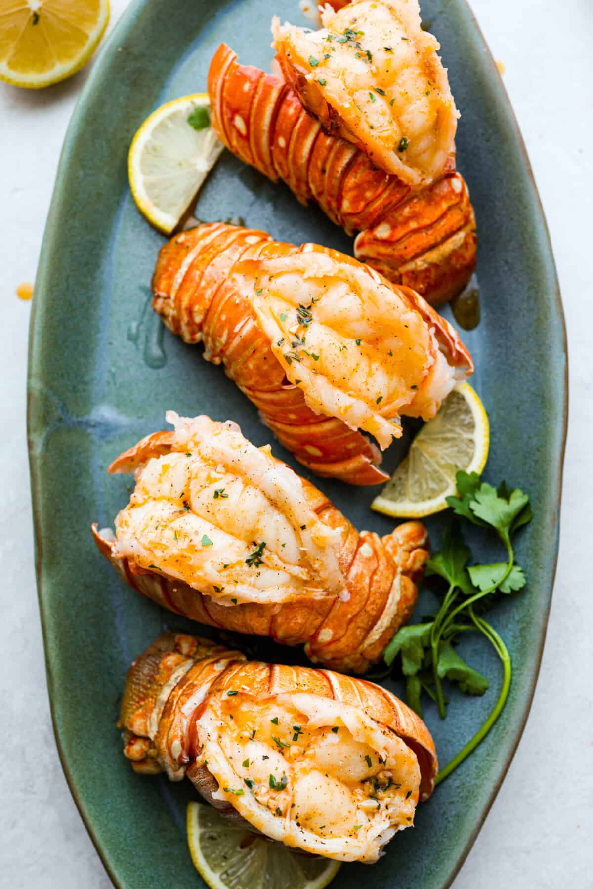 Instant pot lobster is the easiest way to bring a little luxury to your dinner table, no boiling pots or fancy techniques needed! In just minutes, the lobster cooks up tender, juicy, and perfectly steamed, ready to soak up a rich garlic-herb butter. Plated instant pot lobster tails.