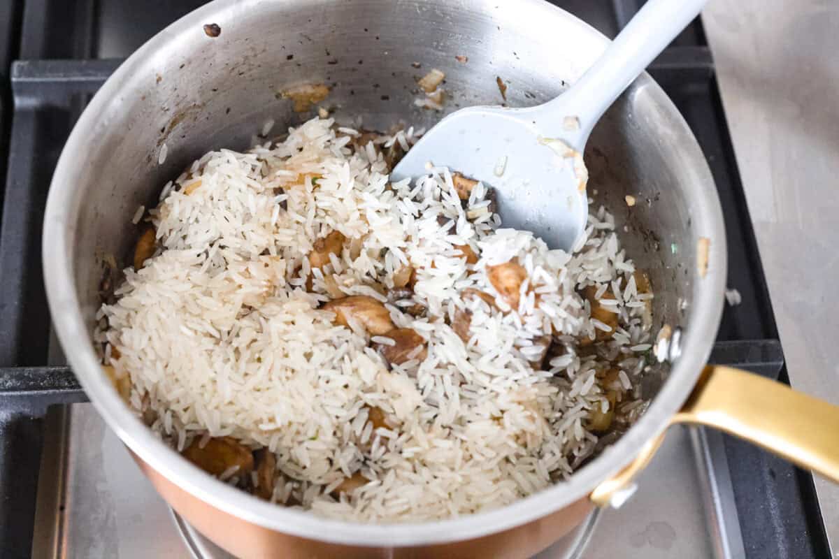 Rice added to the mushrooms.
