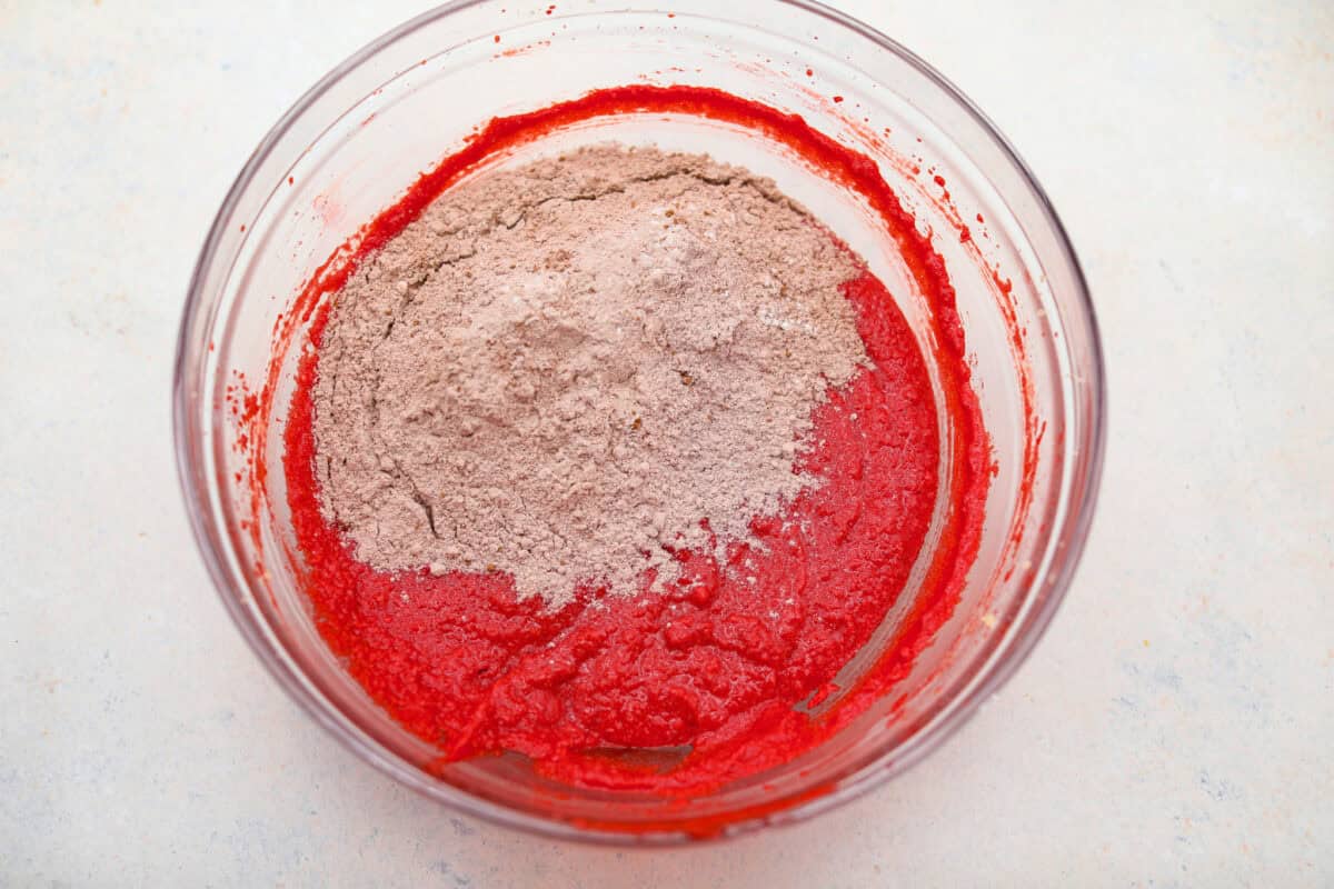 These red velvet crinkle cookies bring all the charm of classic red velvet cake in a festive, crackly cookie. With a soft center, crisp edges, and a snowy sugar coating, they’re as delicious as they are eye-catching. Dry ingredients added to the butter and food coloring mixture.