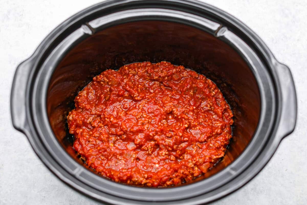 Layer of meat sauce on the bottom of the slow cooker. 