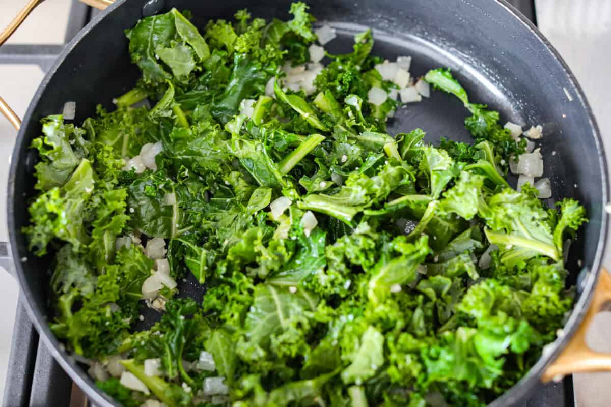 I am begging you guys to make this Zuppa Toscana Casserole! It turns the classic soup into the most delicious bake! It has layers of potatoes, sausage, bacon, kale, and cheese drenched in the most amazing sauce! Make it today, trust me! Kale added to the onion and garlic.