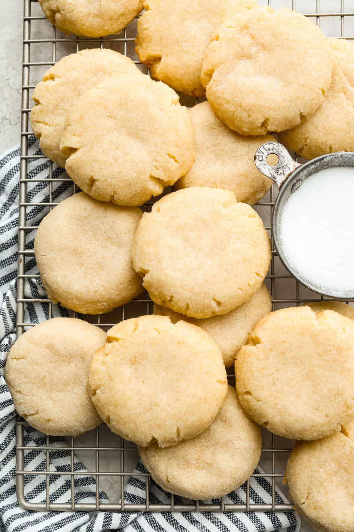 4 ingredient sugar cookies layered on a cooling rack. 