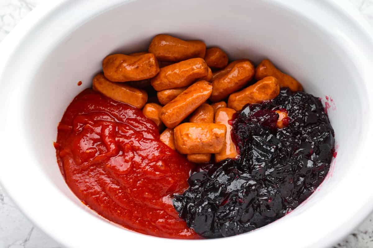 If you’re hosting anything and need a quick appetizer, these crockpot grape jelly little smokies are it. Dump everything in the slow cooker, walk away, and come back to glossy, flavorful sausages that people hover around all night. All of the ingredients added to a crockpot.