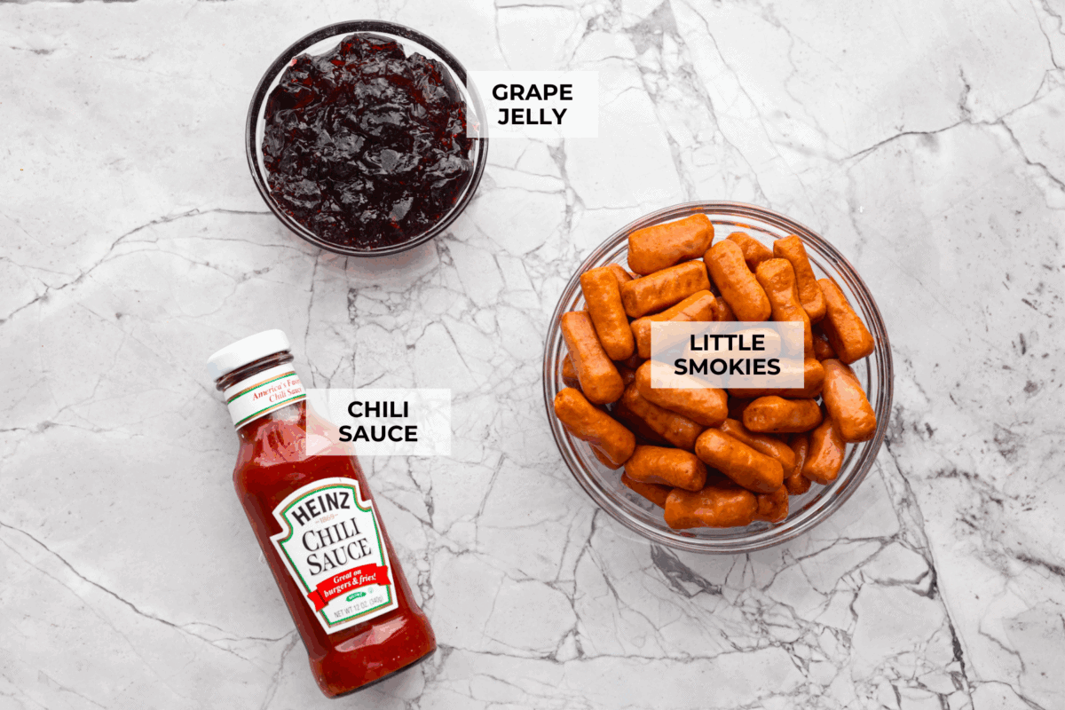 If you’re hosting anything and need a quick appetizer, these crockpot grape jelly little smokies are it. Dump everything in the slow cooker, walk away, and come back to glossy, flavorful sausages that people hover around all night. Overhead shot of labeled crockpot grape jelly little smokies.