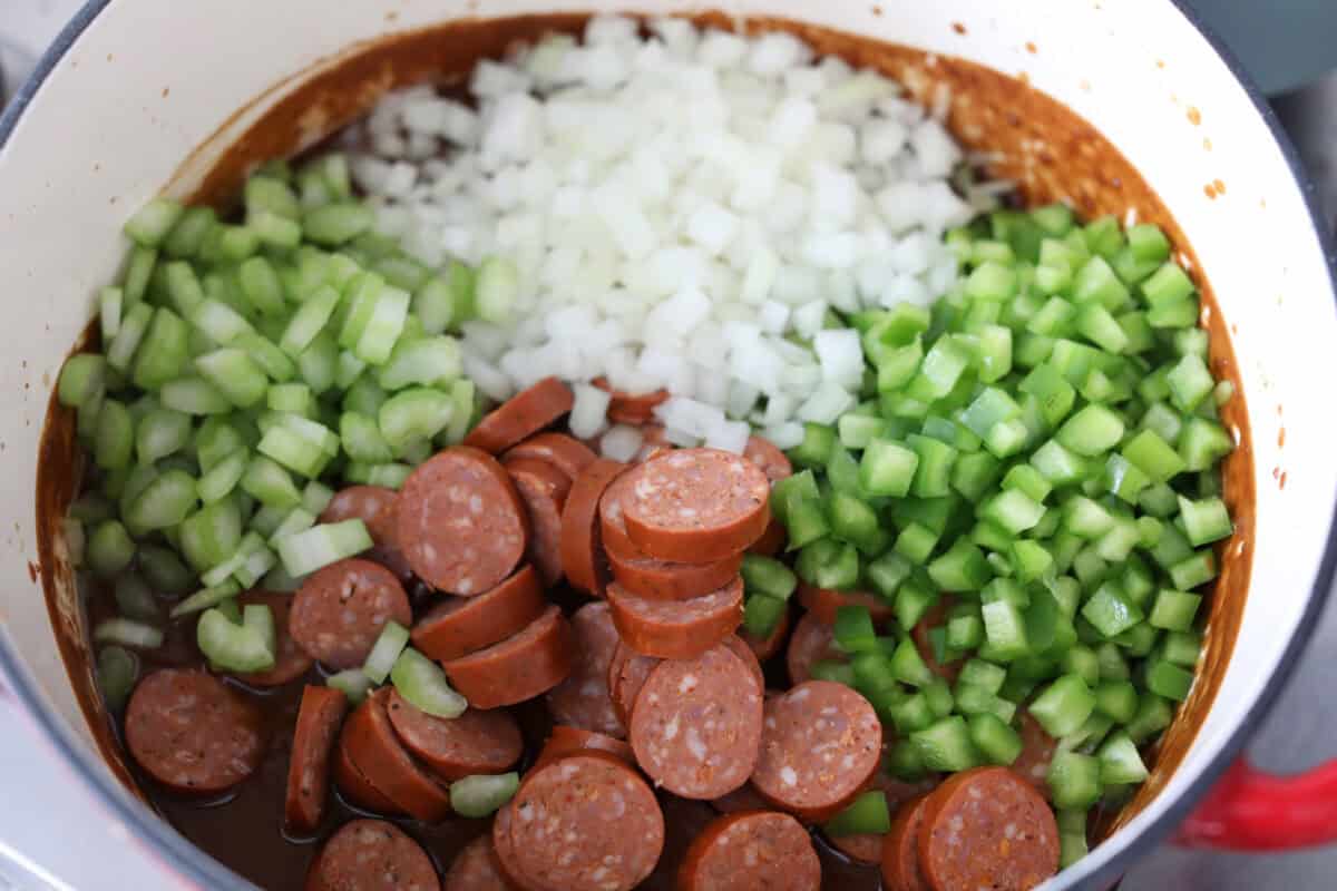 After listening to your feedback and learning what makes a great New Orleans gumbo, I made some changes. This version is richer, more balanced, and way closer to the real deal, without being overwhelming to make at home. Veggies and sausage added to the roux.