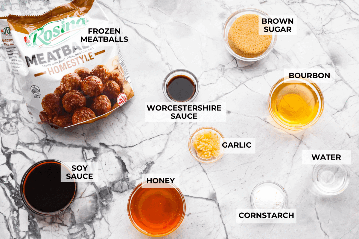 Slow cooker bourbon meatballs are an easy, set-it-and-forget-it favorite. Frozen meatballs simmer in a sweet, sticky bourbon sauce, making them perfect for an appetizer or a simple dinner with just 10 minutes of prep. Overhead shot of labeled ingredients.