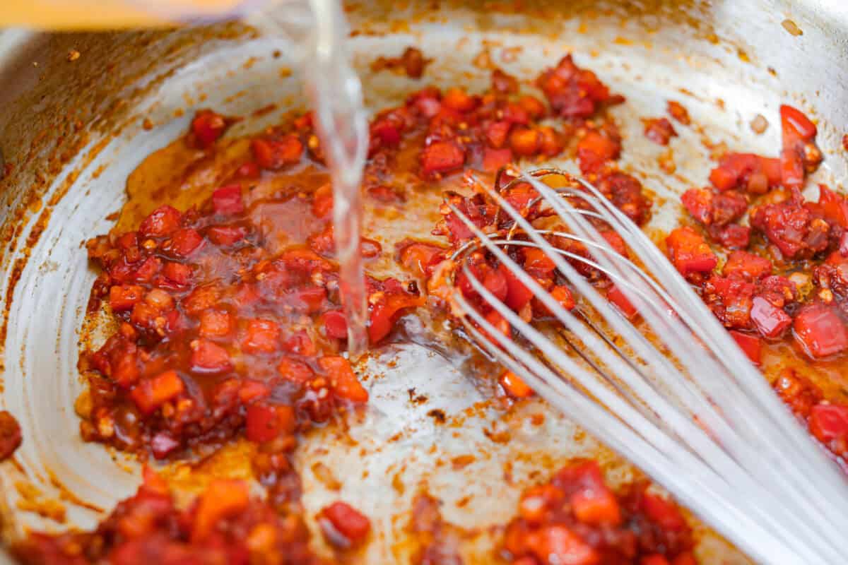 Seasoning and chicken broth added to the veggies. 