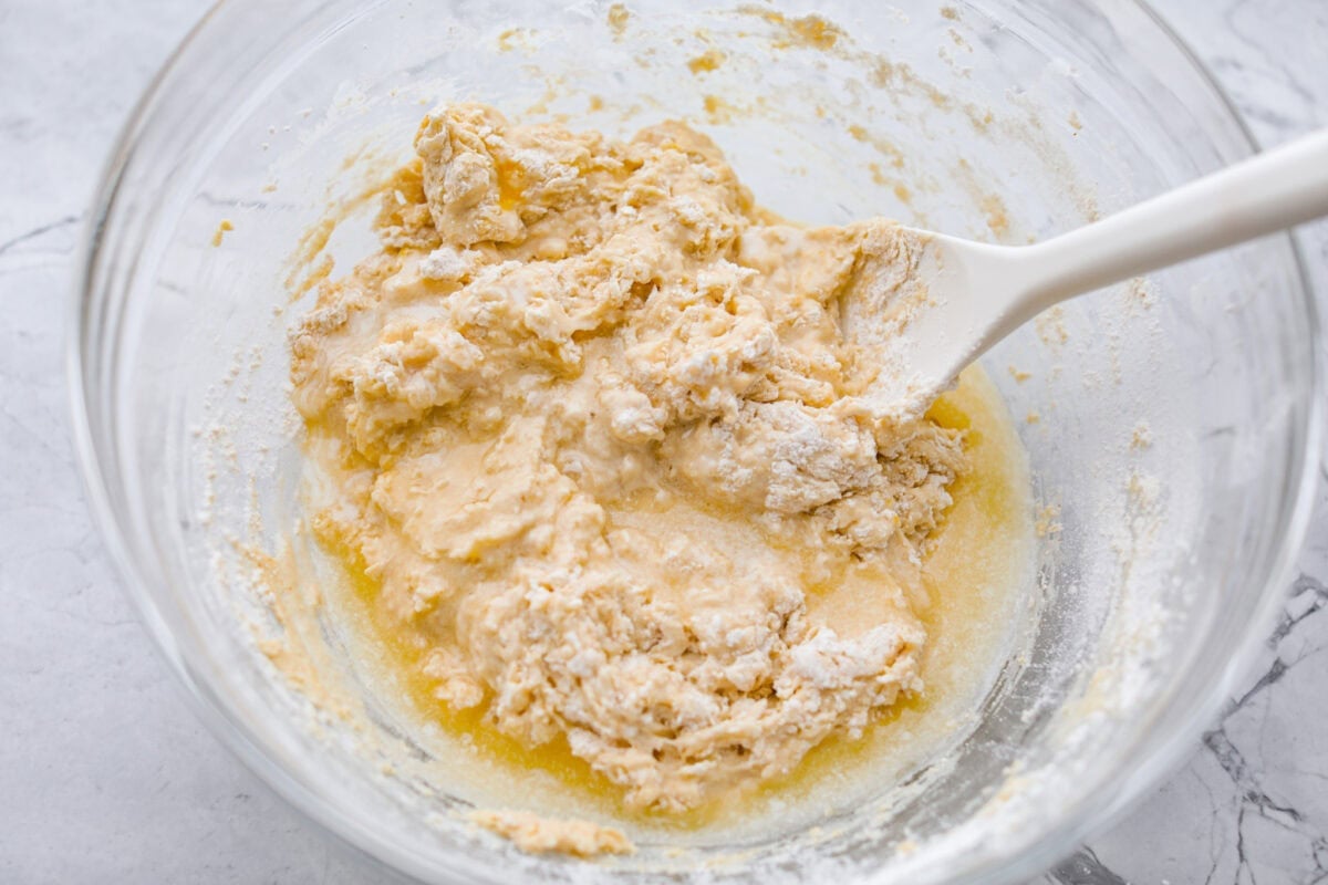 If you love my Red Lobster Biscuits, this Cheddar Bay Biscuit Bread has the same buttery, garlicky cheddar flavor, just mixed and baked right in a bread pan. Slice it warm and serve it with basically anything. It's a must-make! Trust me! Wet and dry ingredients mixed together.