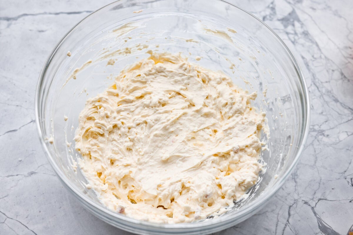 This crack orzo bake is creamy, cheesy, and packed with that irresistible ranch, bacon, and cheddar “crack” flavor everyone loves. It’s an easy casserole that’s guaranteed to be a hit. Cream cheese, cream of chicken soup, and sour cream all mixed together in a mixing bowl.