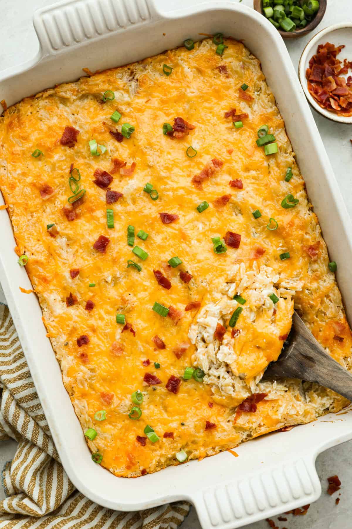 This crack orzo bake is creamy, cheesy, and packed with that irresistible ranch, bacon, and cheddar “crack” flavor everyone loves. It’s an easy casserole that’s guaranteed to be a hit. Top down shot of the completed crack chicken orzo bake ready to serve.