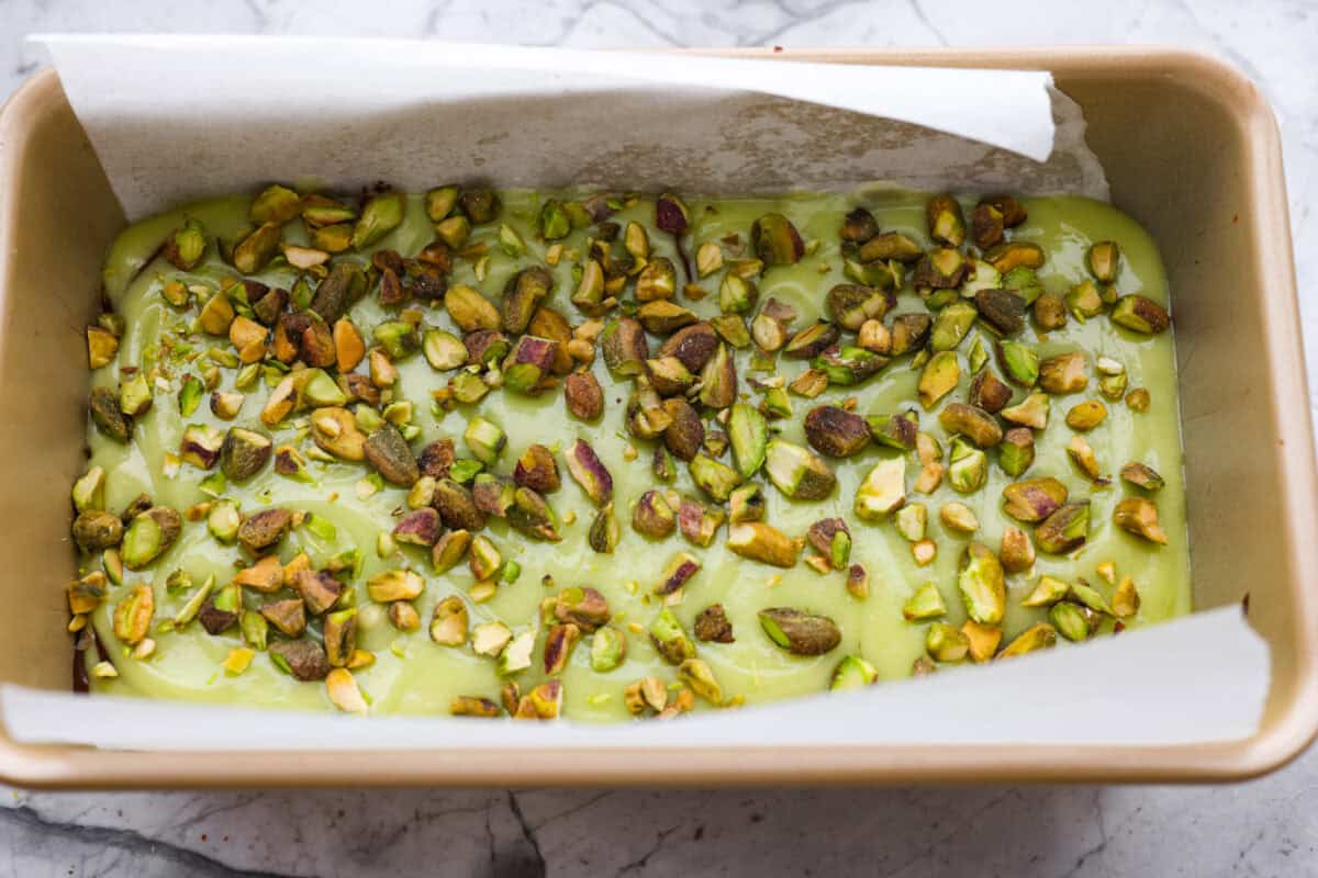 Starbucks dropped a new Chocolate Pistachio Loaf, and I was instantly obsessed. The pistachio flavor and that rich chocolate swirl had me determined to make a copycat at home so I could skip the drive-thru and bake it anytime. Pistachios added to the top of the batter.